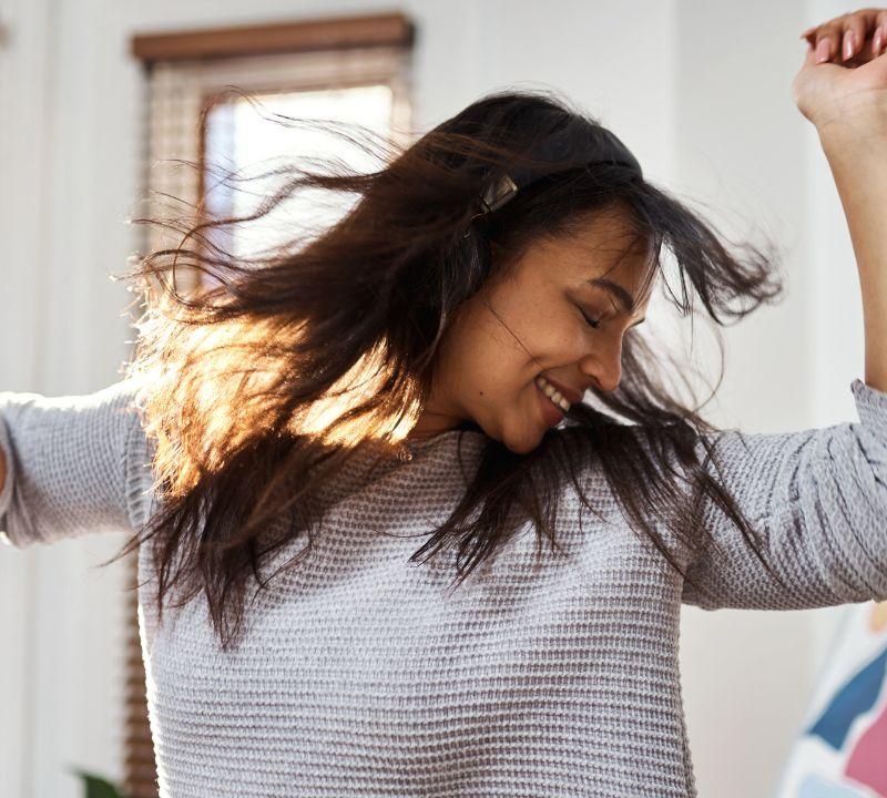 Happy coach dancing in front of a laptop after launching a new coaching website designed to grow an online coaching business Happy coach dancing in front of a laptop after launching a new coaching website designed to grow an online coaching business