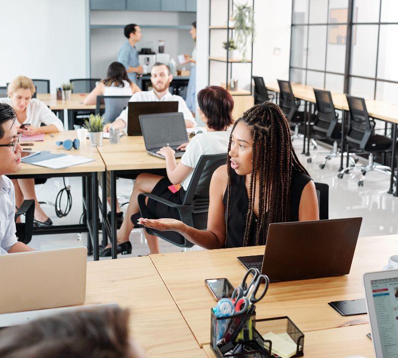 Diverse team of web designers collaborating in a bright, modern coaching website design agency office Diverse team of web designers collaborating in a bright, modern coaching website design agency office